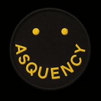 a black patch with a yellow smiley face on it