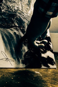 a person is holding a piece of paper with a drawing on it